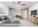 Virtually staged main bedroom with ceiling fan and large window at 1506 Maple Dr, Berthoud, CO 80513