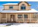 Two-story house with a covered porch, snow on the ground, and visible architectural details at 1506 Maple Dr, Berthoud, CO 80513