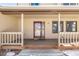 Wooden front porch with railing and entry door, steps leading to the ground at 1506 Maple Dr, Berthoud, CO 80513