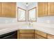 Kitchen corner sink with wood cabinets and white countertop at 1506 Maple Dr, Berthoud, CO 80513