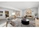 Virtually staged living room with comfortable furniture and adjacent kitchen view at 1506 Maple Dr, Berthoud, CO 80513