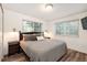 Cozy bedroom features wood-look floors, two windows, and neutral decor for a relaxing atmosphere at 13744 E Lehigh Ave # B, Aurora, CO 80014