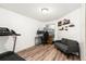 Bedroom featuring laminate floors, comfortable seating, desk space, and natural light at 13744 E Lehigh Ave # B, Aurora, CO 80014