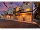 Townhome exterior with garages and balconies at dusk at 13744 E Lehigh Ave # B, Aurora, CO 80014