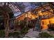 Inviting two-story condo with brick facade, private balcony, and landscaped grounds at dusk at 13744 E Lehigh Ave # B, Aurora, CO 80014