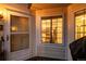Cozy front porch featuring a bright entryway door, window, and outdoor grill at 13744 E Lehigh Ave # B, Aurora, CO 80014