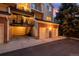 View of a two-car garage, external staircase, and condo unit with parking space at 13744 E Lehigh Ave # B, Aurora, CO 80014