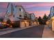 Exterior view of garages with tan doors, and an adjacent two-story condo complex at 13744 E Lehigh Ave # B, Aurora, CO 80014
