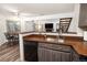 Kitchen with stainless steel sink and view of living and dining areas at 13744 E Lehigh Ave # B, Aurora, CO 80014