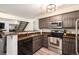 Modern kitchen featuring stainless steel appliances and wooden cabinets at 13744 E Lehigh Ave # B, Aurora, CO 80014