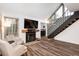 Inviting living area with a fireplace, TV, and staircase leading to the upper level at 13744 E Lehigh Ave # B, Aurora, CO 80014