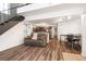Open living space with wood floors, staircase, and view of kitchen and dining area at 13744 E Lehigh Ave # B, Aurora, CO 80014