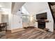 Bright living room featuring fireplace, large windows and modern flooring at 13744 E Lehigh Ave # B, Aurora, CO 80014