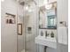 Modern bathroom with glass shower, vanity with sink and decorative mirror at 8540 W 59Th Ave, Arvada, CO 80004