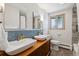 Bathroom with dual sinks, stylish backsplash, and decorative tile at 8540 W 59Th Ave, Arvada, CO 80004