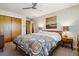 Bedroom with ceiling fan, patterned quilt, and bedside tables at 8540 W 59Th Ave, Arvada, CO 80004