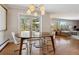 Dining room features a modern light fixture, table, and access to patio at 8540 W 59Th Ave, Arvada, CO 80004