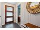 Inviting entryway with modern door, decorative mirror, and stylish wood accents creates a warm, welcoming atmosphere at 8540 W 59Th Ave, Arvada, CO 80004