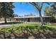 Charming single-story home boasts a well-maintained lawn and a brick exterior, complemented by mature trees at 8540 W 59Th Ave, Arvada, CO 80004