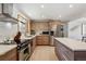 Stylish kitchen featuring stainless appliances, white countertops and wooden cabinetry with an island perfect for entertaining at 8540 W 59Th Ave, Arvada, CO 80004