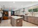 Modern kitchen with stainless steel appliances, custom cabinets, and a center island perfect for cooking and entertaining at 8540 W 59Th Ave, Arvada, CO 80004