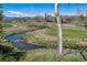 Scenic view of a stream flowing through a green, landscaped area with a bridge at 8540 W 59Th Ave, Arvada, CO 80004