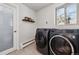 Laundry room features modern washer and dryer and a window at 8540 W 59Th Ave, Arvada, CO 80004