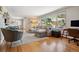 Spacious living room with large windows, hardwood floors, and comfortable seating at 8540 W 59Th Ave, Arvada, CO 80004