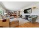 Bright and airy living room featuring a fireplace, hardwood floors and modern seating at 8540 W 59Th Ave, Arvada, CO 80004