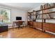 Home office features wood floors, built-in shelving, modern desk and large window at 8540 W 59Th Ave, Arvada, CO 80004