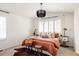 Main bedroom with a king bed, side tables, and large windows at 10283 Spotted Owl Ave, Highlands Ranch, CO 80129