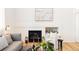 Living room with a fireplace and built in shelving, hardwood floors and comfortable seating at 10283 Spotted Owl Ave, Highlands Ranch, CO 80129