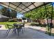 Outdoor patio with metal shade, table, chairs, grass and greenery perfect for backyard relaxation at 3147 W 39Th Ave, Denver, CO 80211