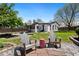 Backyard with a patio, chairs, grass, and mature tree, perfect for enjoying outdoor living at 3147 W 39Th Ave, Denver, CO 80211