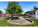 Backyard with an open patio space, landscaping, and a mature tree at 3147 W 39Th Ave, Denver, CO 80211