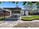 The backyard features a covered patio, quaint building, stone landscaping and green grass at 3147 W 39Th Ave, Denver, CO 80211