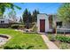 Backyard featuring a landscaped area with a red door and plenty of yard space at 3147 W 39Th Ave, Denver, CO 80211