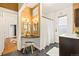 Spacious bathroom featuring dual vanity, shower/tub, and stylish patterned wallpaper at 3147 W 39Th Ave, Denver, CO 80211