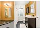 Bathroom featuring dual vanity, marble floors, and shower/tub with modern finishes at 3147 W 39Th Ave, Denver, CO 80211