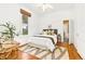 Bright bedroom with hardwood floors, decorative chair, and a bright window at 3147 W 39Th Ave, Denver, CO 80211