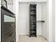 Walk-in closet features custom black cabinets and drawers, plus neutral carpeted flooring at 3147 W 39Th Ave, Denver, CO 80211