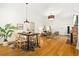 Open-concept dining area featuring hardwood floors, a modern table, and stylish lighting at 3147 W 39Th Ave, Denver, CO 80211