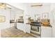 Bright kitchen features stainless steel appliances, white cabinets and tile floors at 3147 W 39Th Ave, Denver, CO 80211