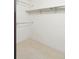 Empty walk-in closet featuring white walls, neutral carpet, and metal shelving at 3470 S Poplar St # 401, Denver, CO 80224