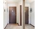 Hallway entryway with doors, laminate flooring, and utility access panel at 3470 S Poplar St # 401, Denver, CO 80224