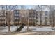 Exterior of building with stair access, mature trees, and architectural facade at 3470 S Poplar St # 401, Denver, CO 80224