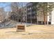 View of the building exterior featuring the community sign, landscaping, and architectural details at 3470 S Poplar St # 401, Denver, CO 80224