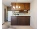 Kitchen view with breakfast bar open to living space and retro features at 3470 S Poplar St # 401, Denver, CO 80224