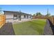 A perfect backyard features newly installed turf, rock, and wood fencing; perfect for entertaining at 3216 Elizabeth, Denver, CO 80205