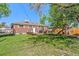 Spacious backyard with well-maintained lawn, wooden deck, and play structure, perfect for outdoor enjoyment at 11320 Irma Dr, Northglenn, CO 80233